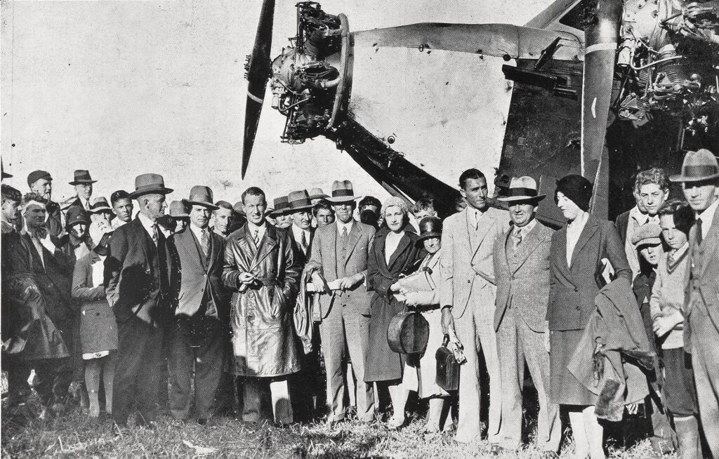 Kingsford Smith (centre in leather coat) and passengers of first A.N.A flight to Western Junction, January 1931 [Weekly Courier]